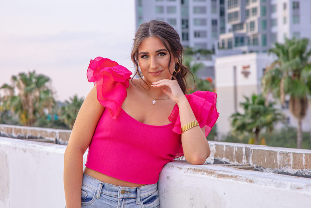 graduation girl on the top of a parking garage