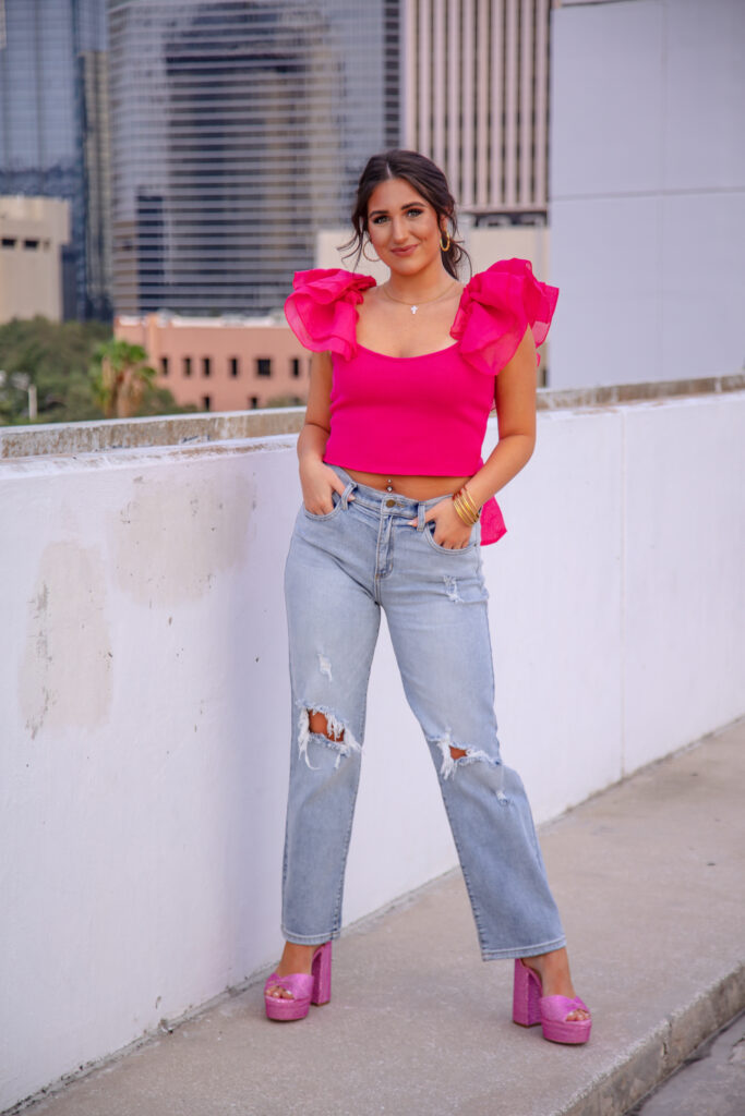 graduation girl on the top of a parking garage
