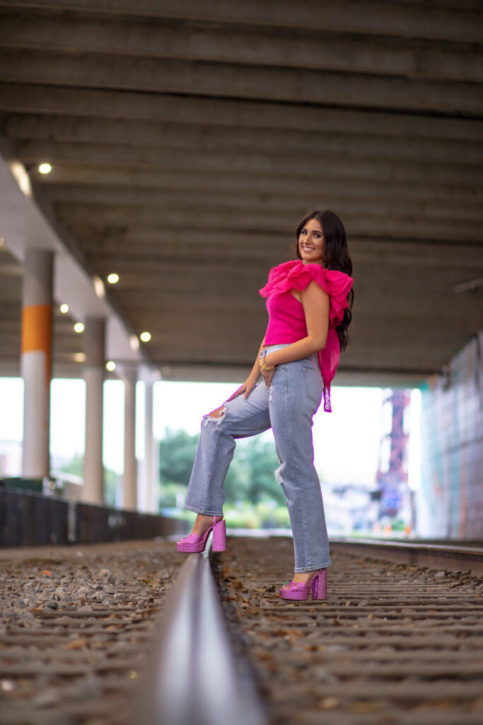 graduation girl on the railroad tracks