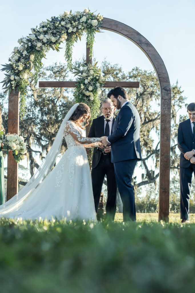 Wedding ceremony on a lawn outside a barn