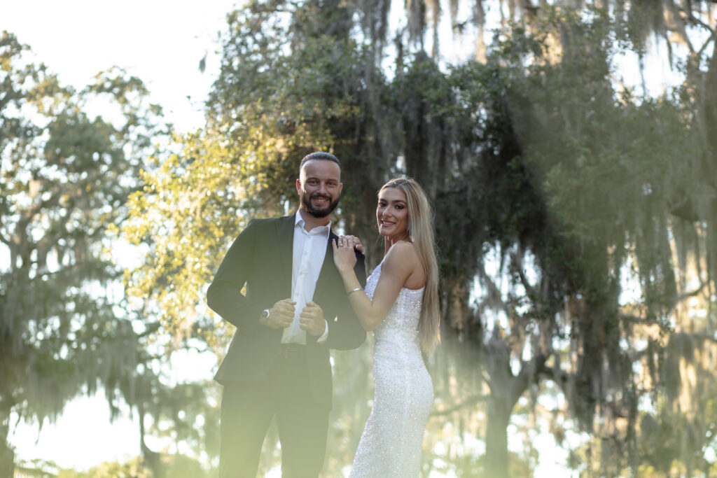 couple posing under a huge tree