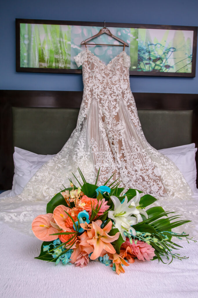 wedding dress hanging above the bed