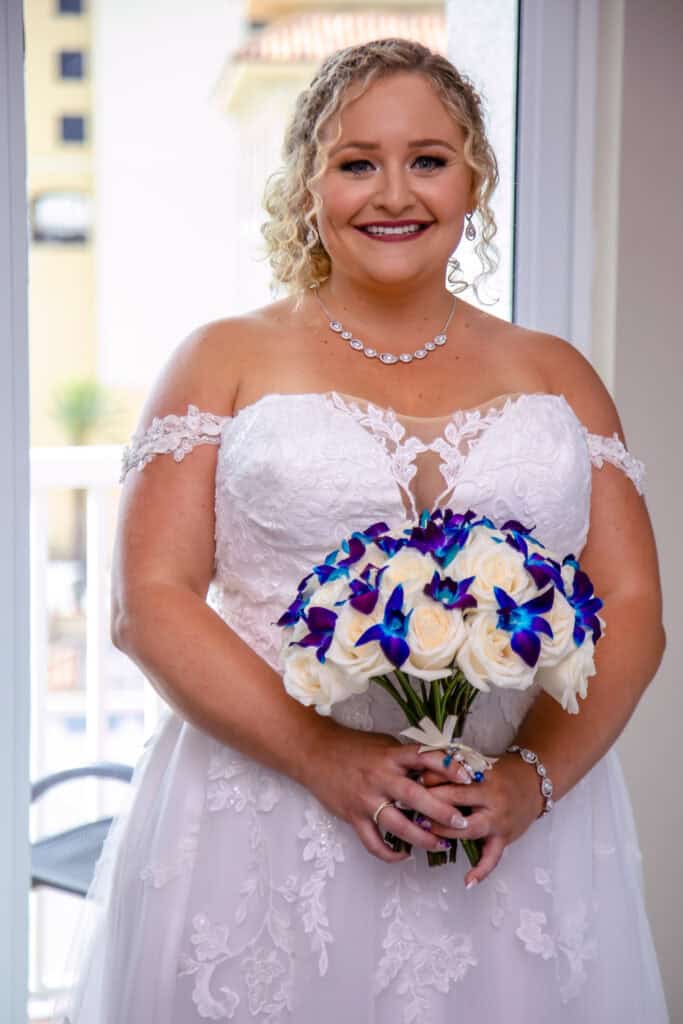 bride in her wedding dress with flowers