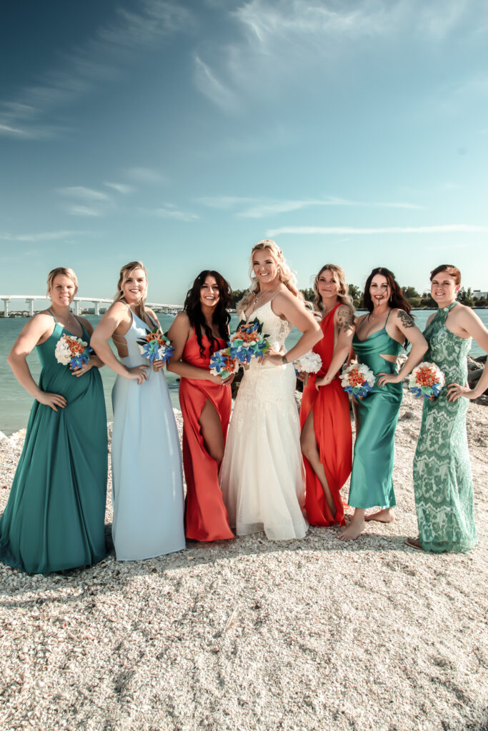 bridesmaids posing on the beach
