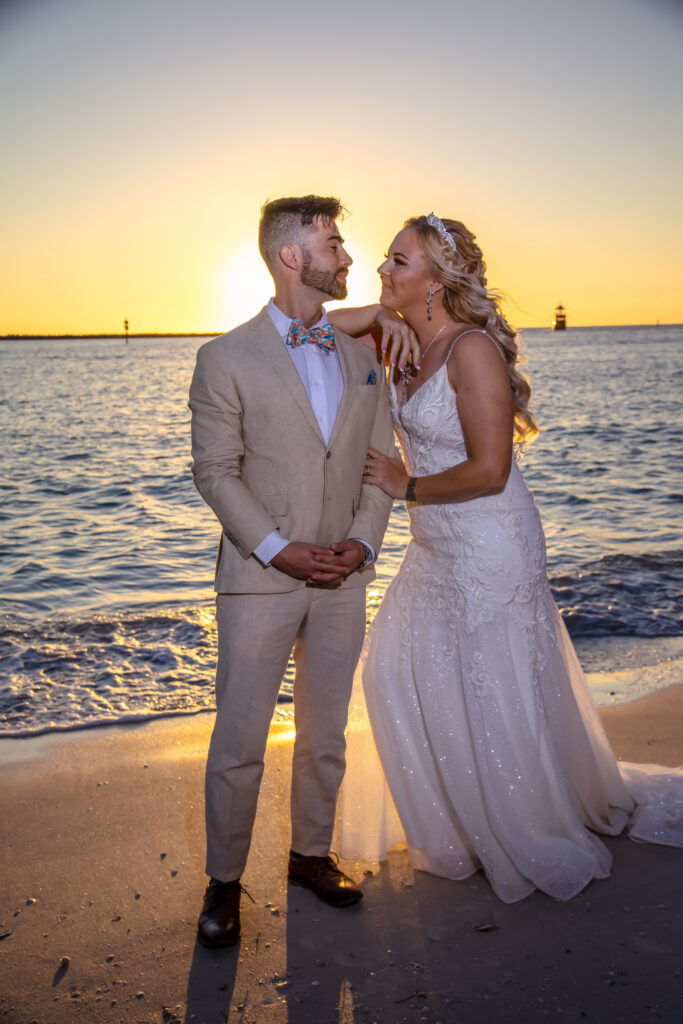 bride and groom on the beach at sunset