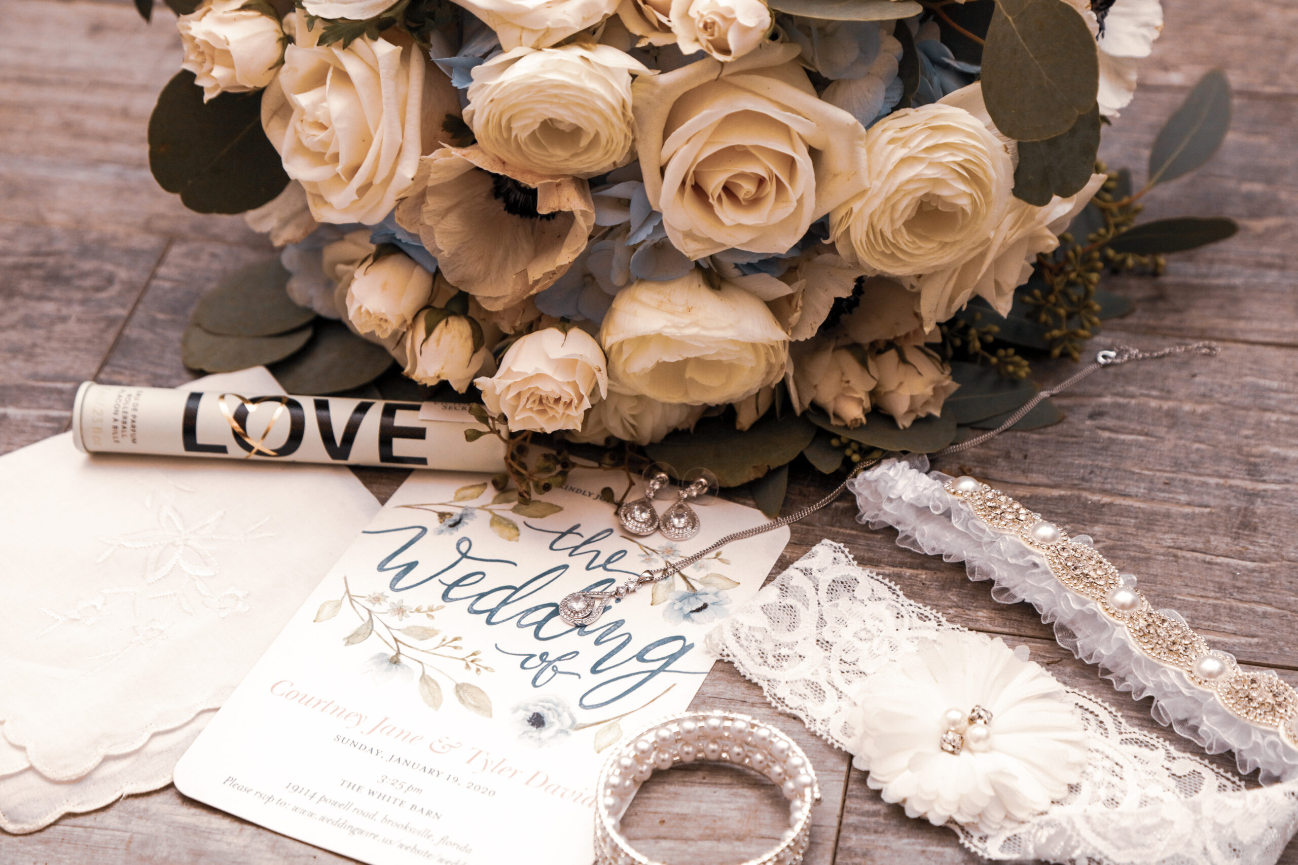 bride's pre ceremony wedding details, flowers, invitation, garter, bracelet, hankerchief