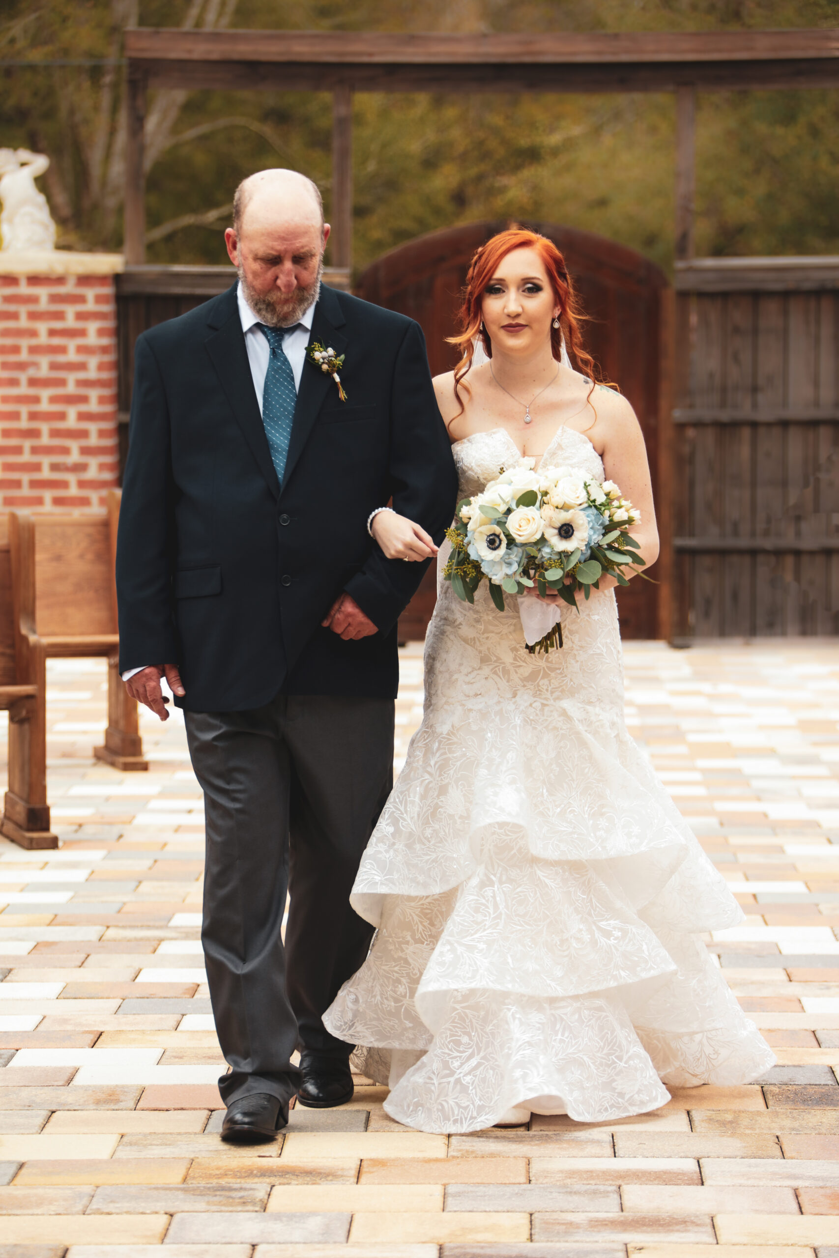 bride walking down the wedding ceremony isle with her dad