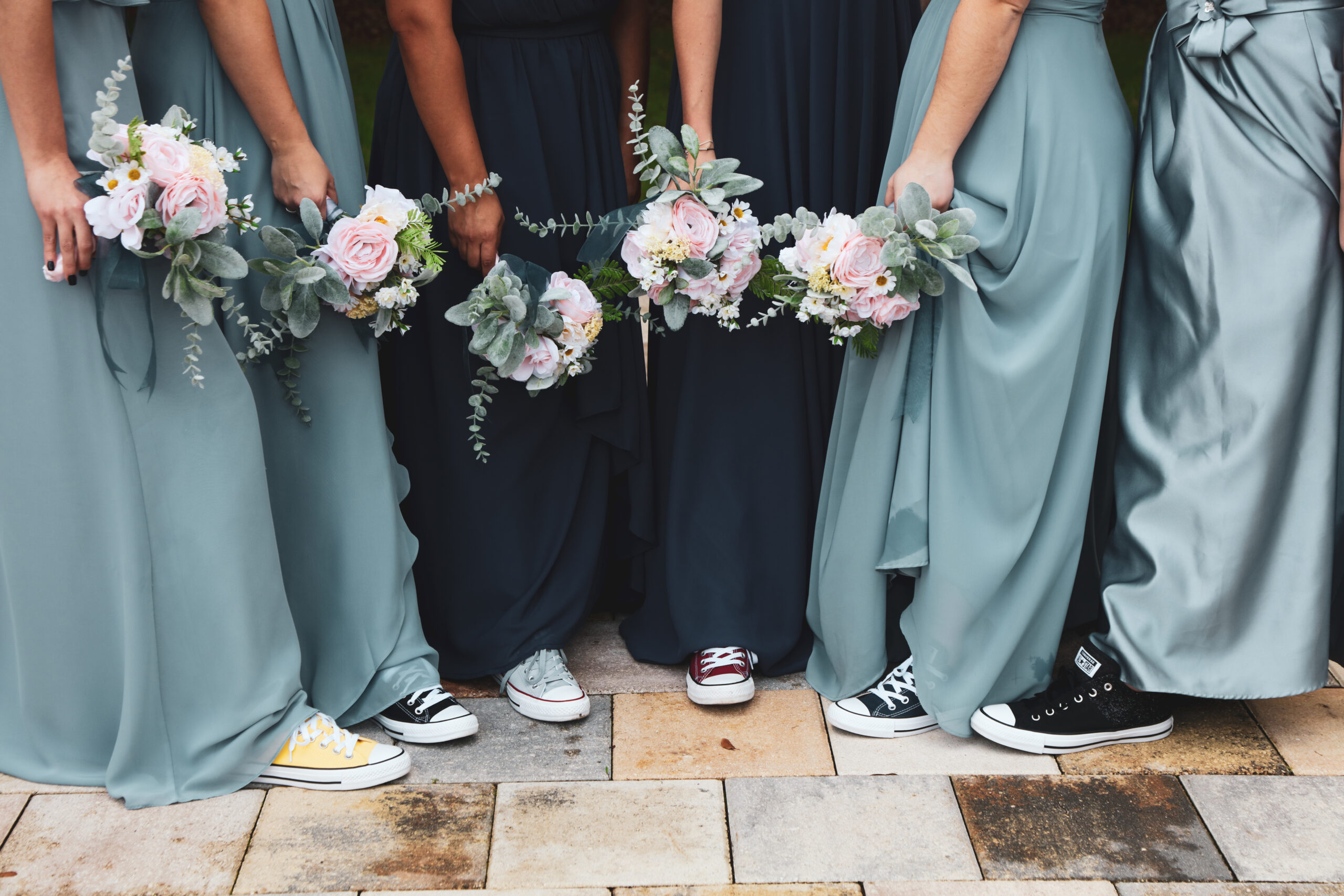 bridemaids with their flowers and Converse shoes