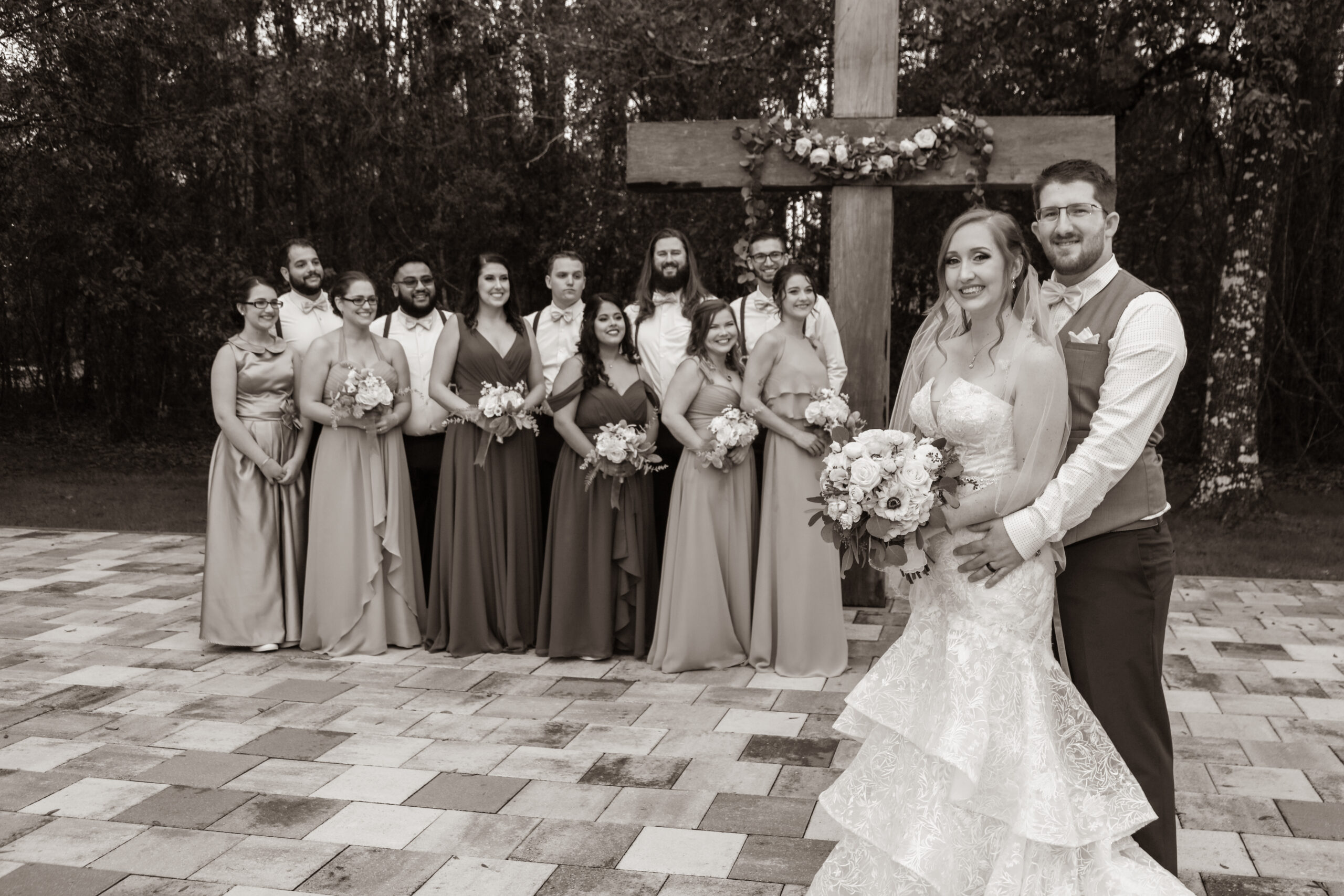 bride and groom with bridal party at the wedding ceremony site outdoors