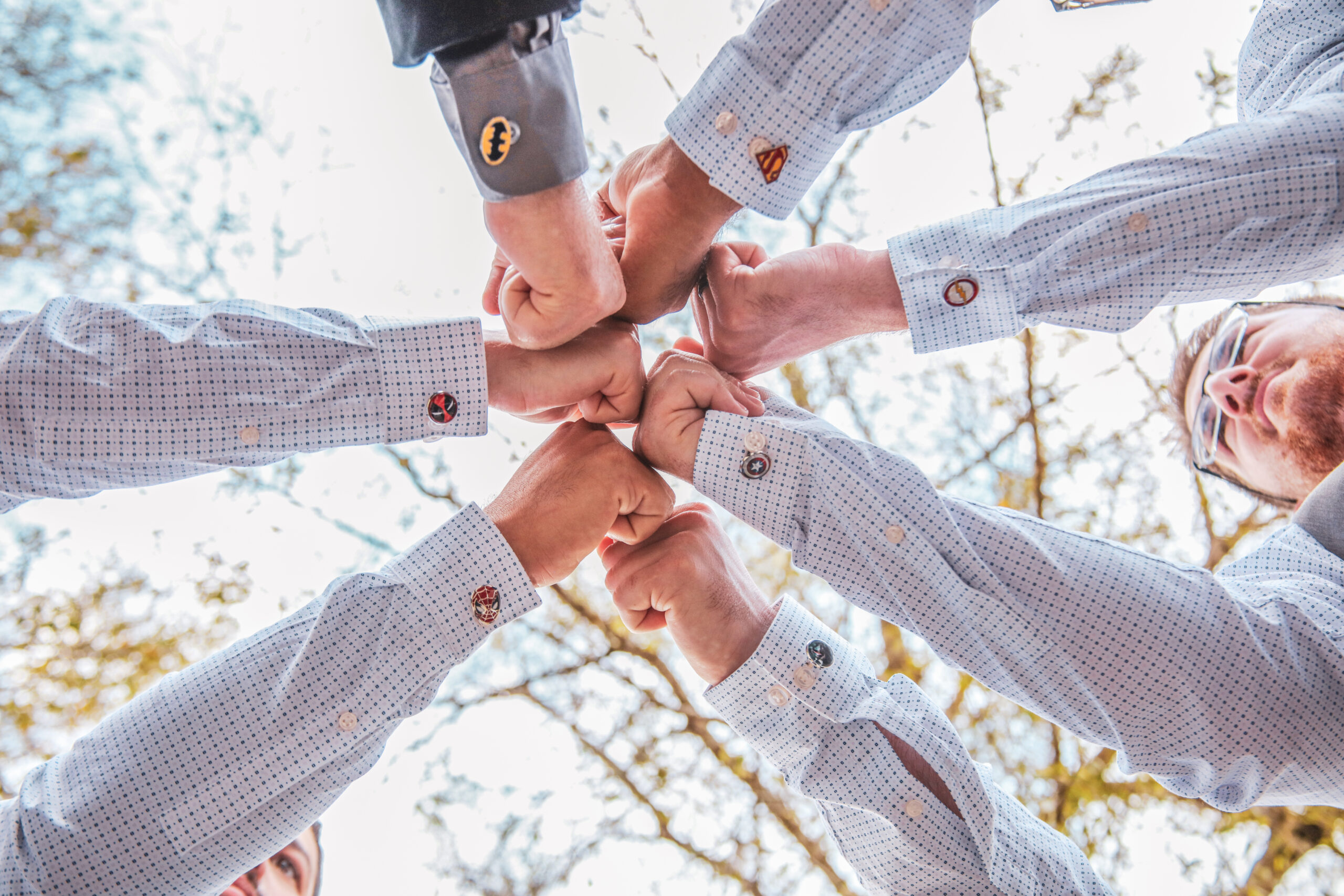 groomsmen stretching the arms in a circle to see their cuff links