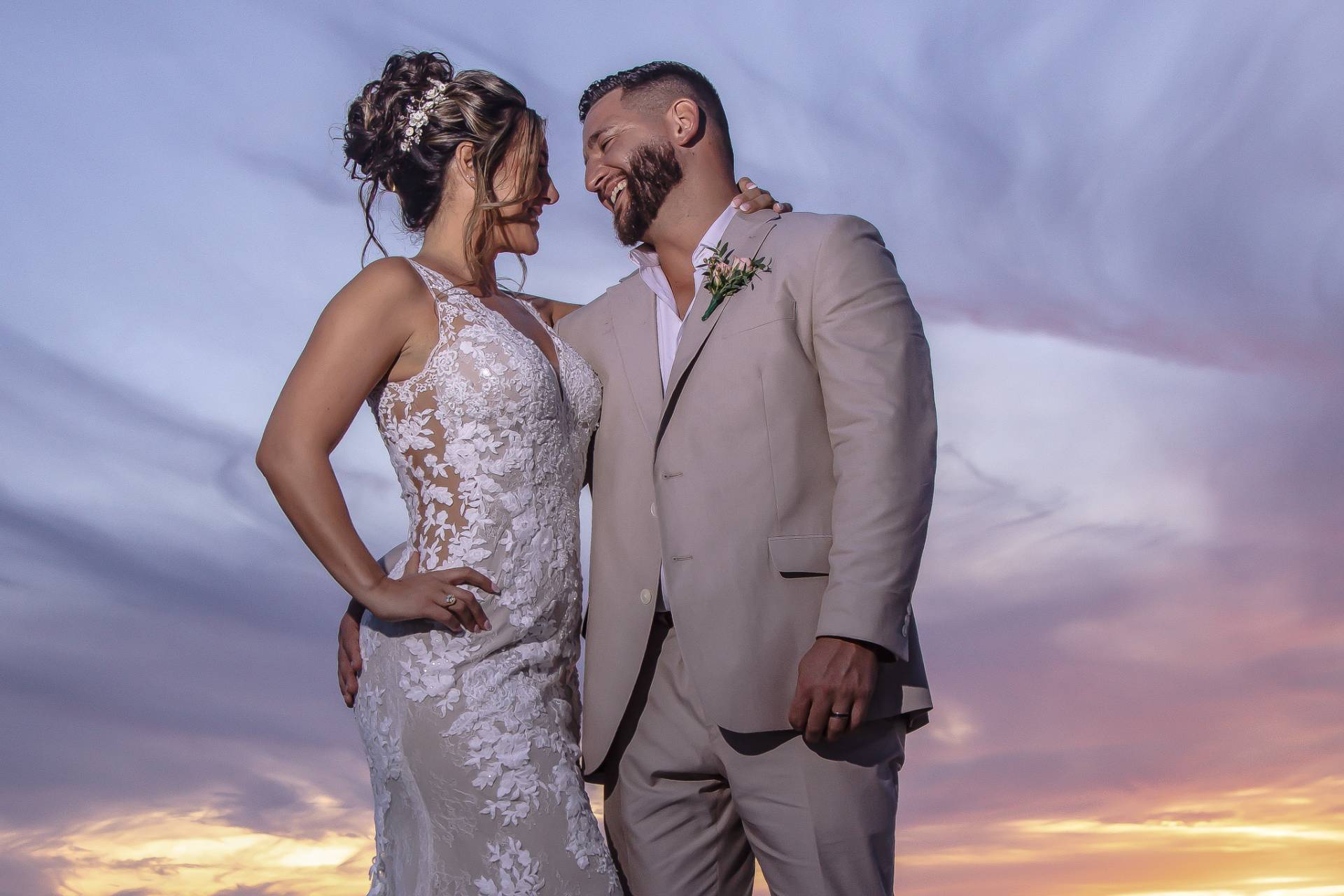 bride and groom on the beach at sunset