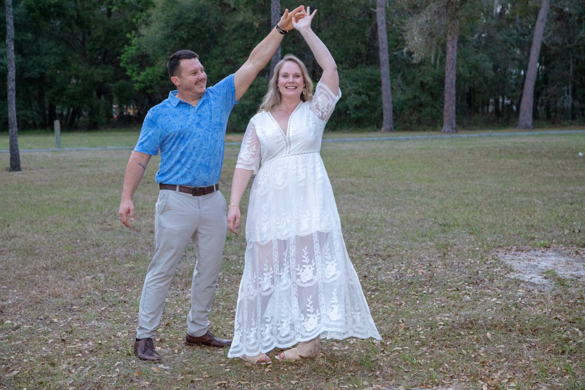 man and woman dancing in the park