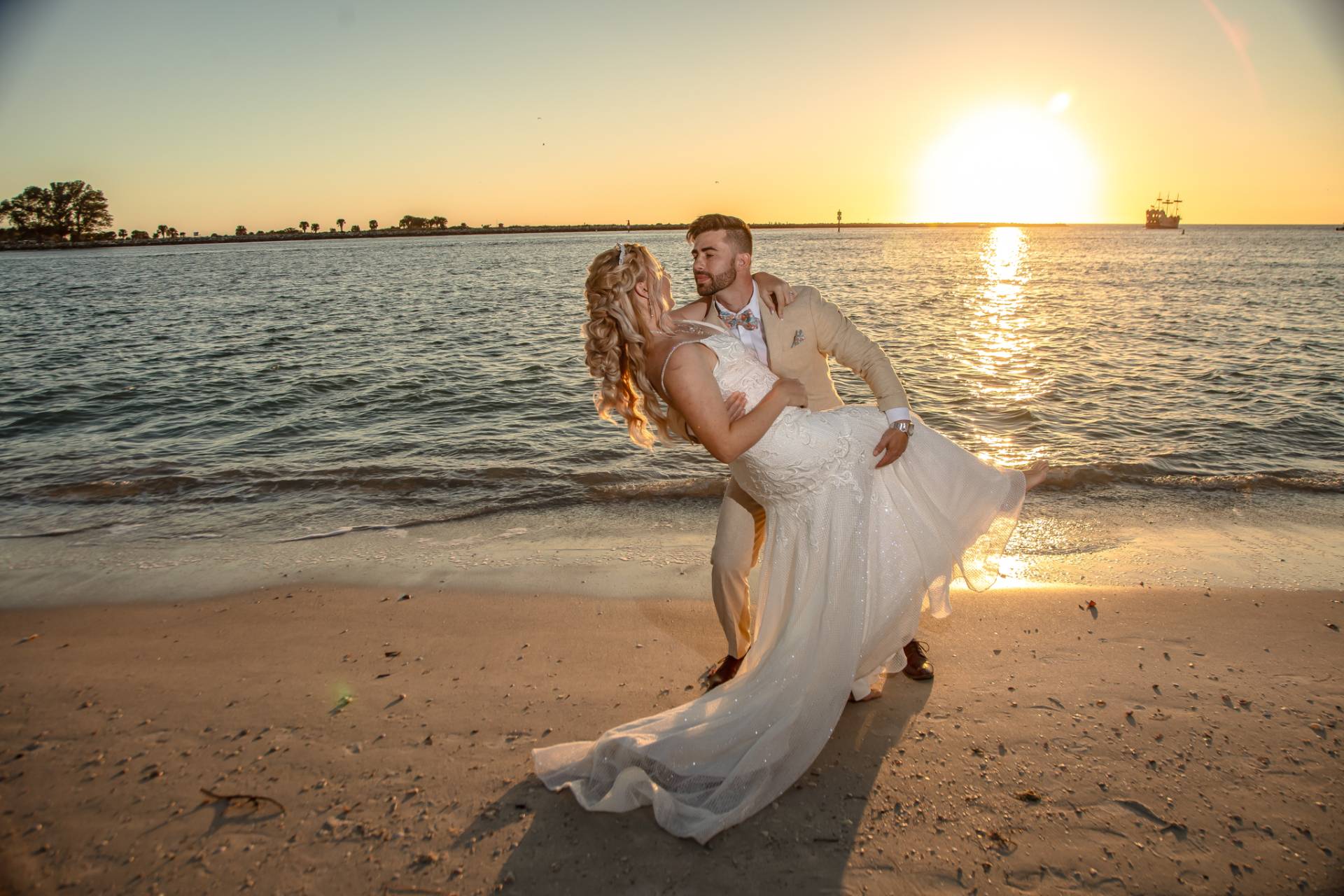 bride and groom on the beach at sunset