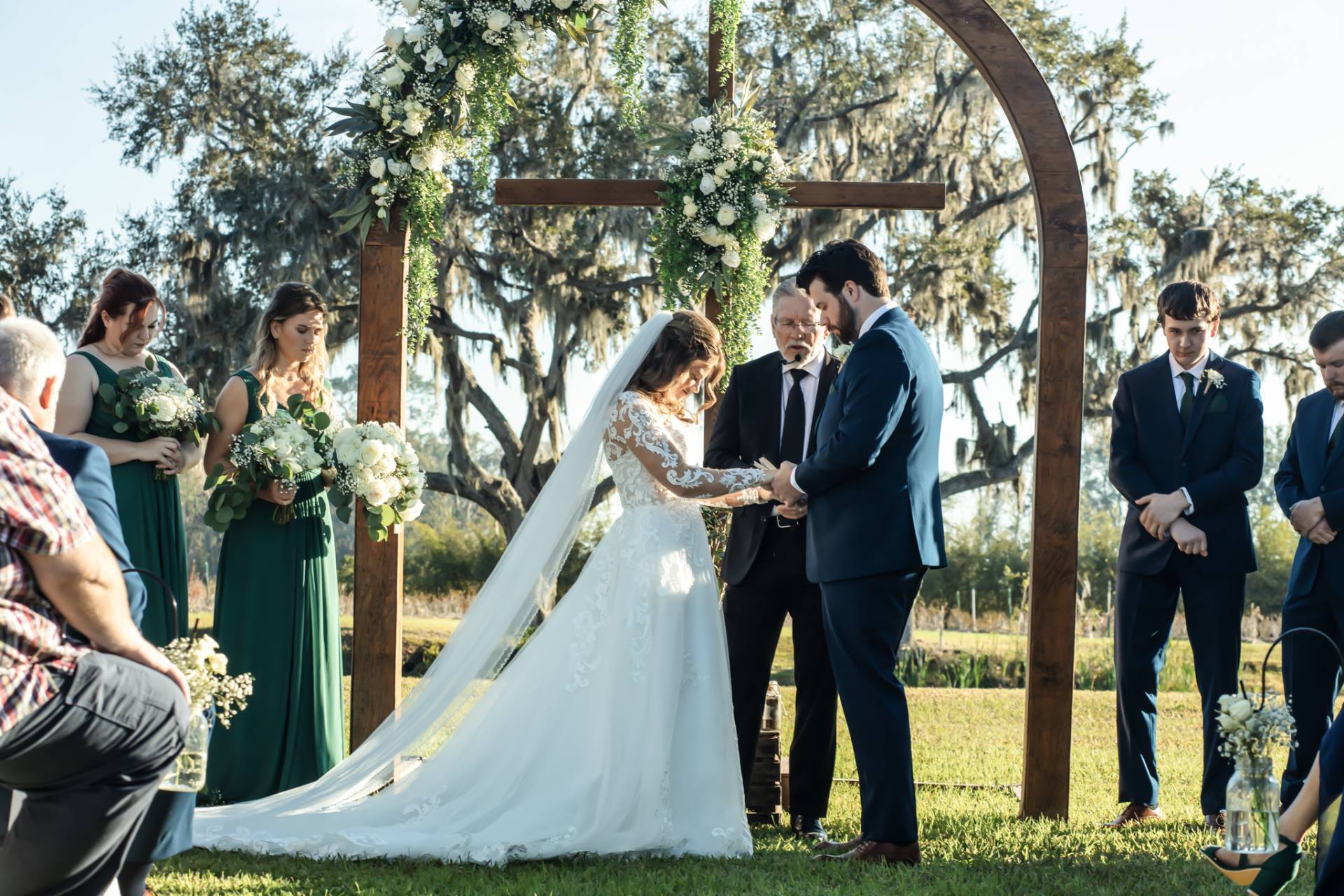 Wedding ceremony on a lawn outside of a barn