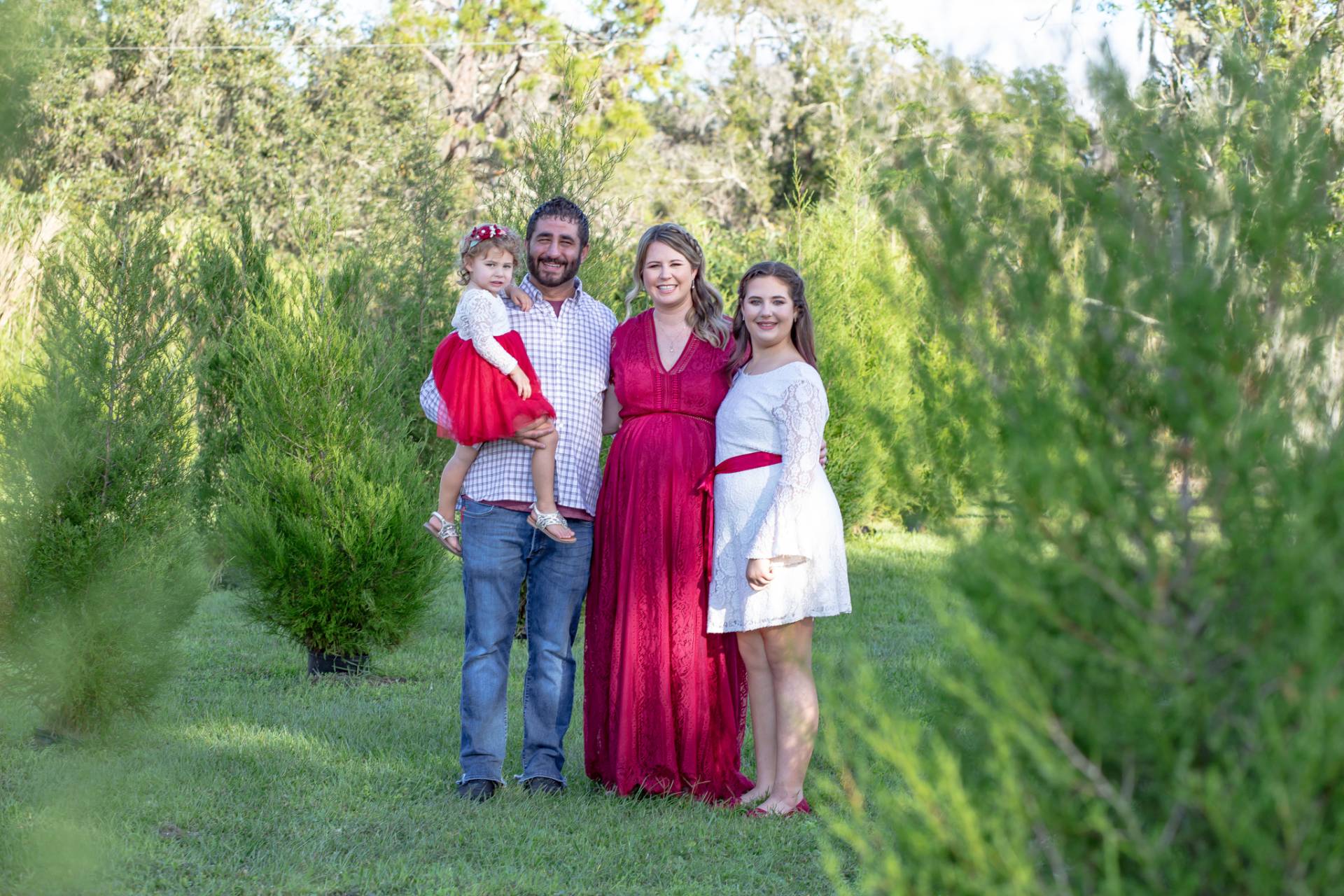 family of four in a vineyard