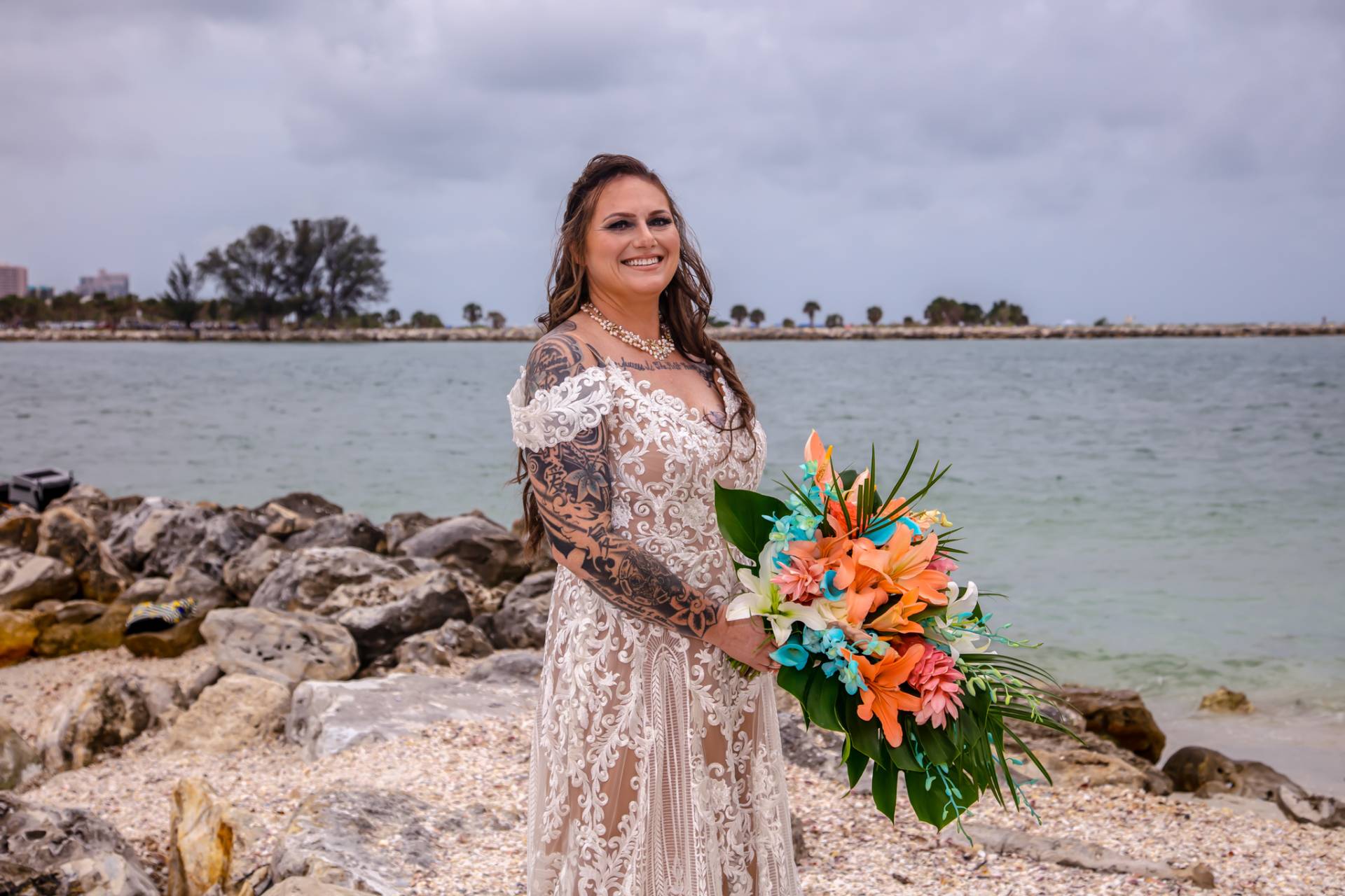 bride with her flowers on the beach