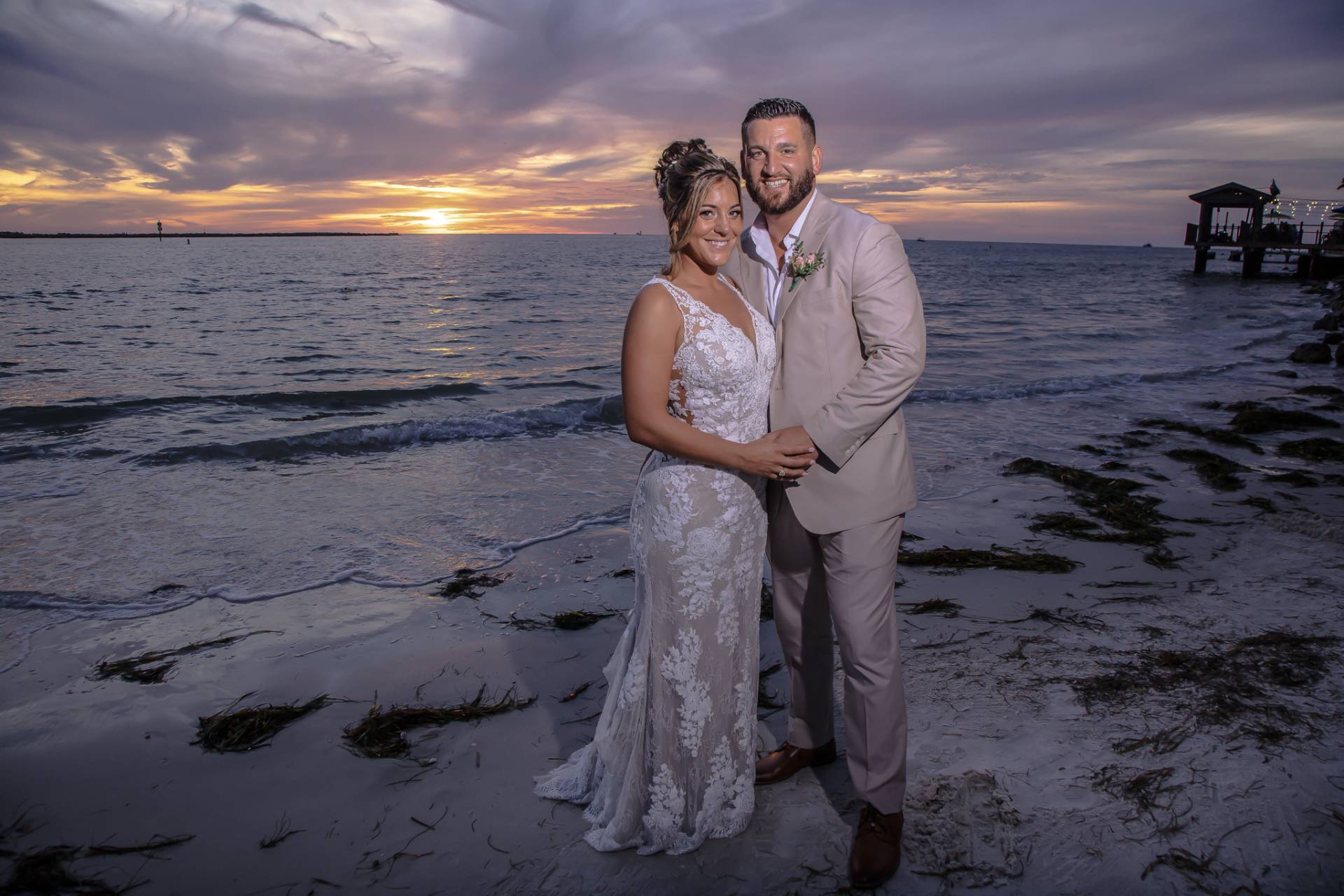 bride and groom on the beach at sunset