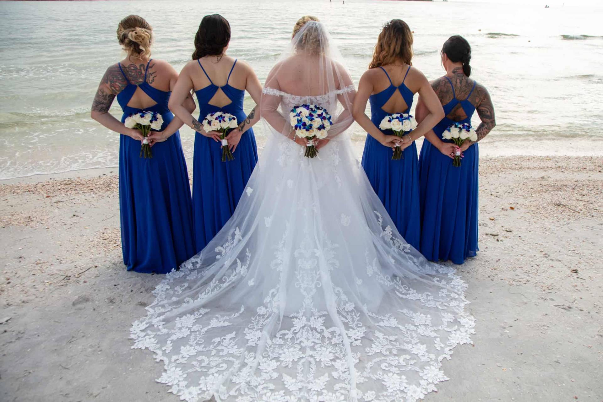 bride with her bridesmaids on the beach