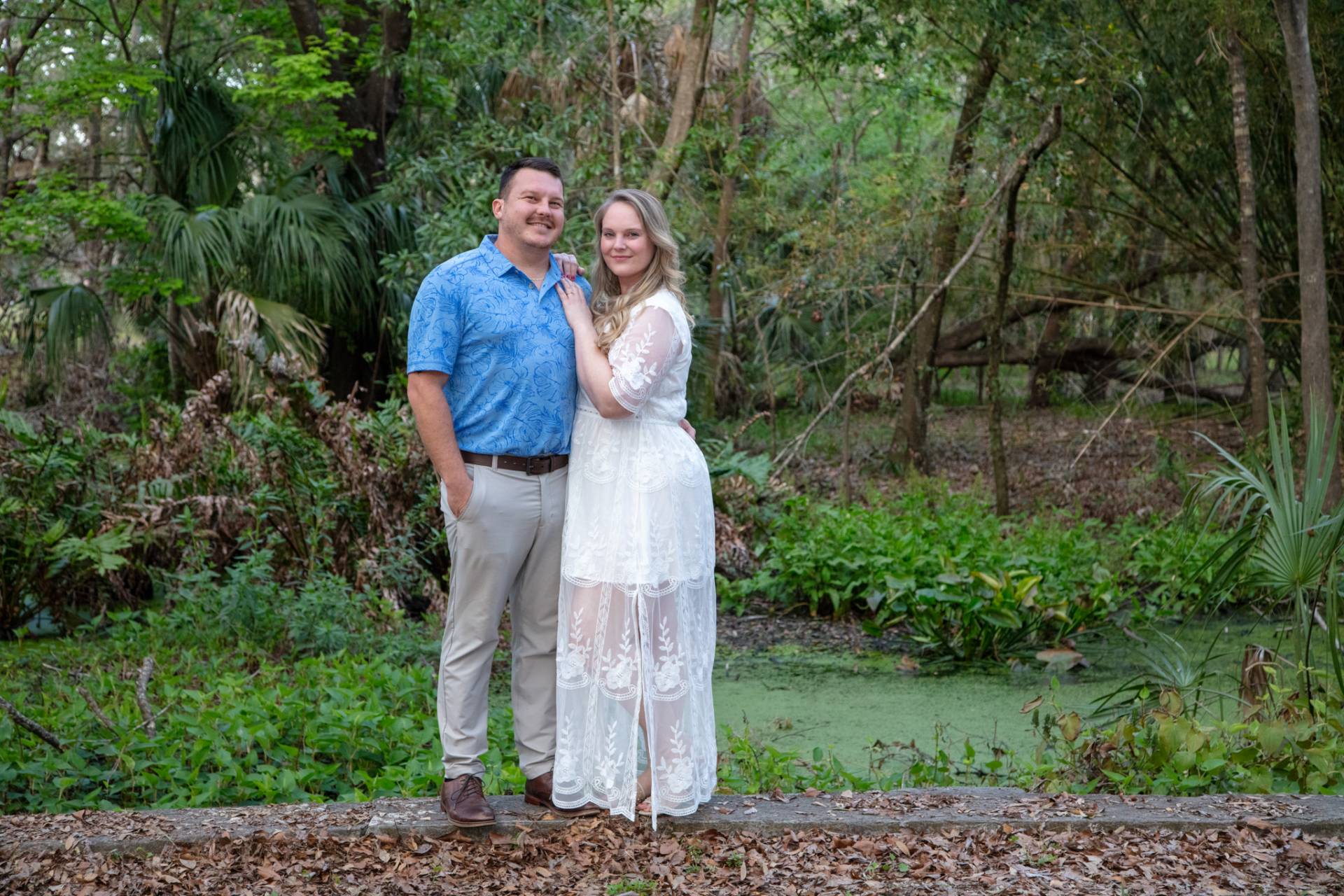woman hanging on a mans shoulder in the park
