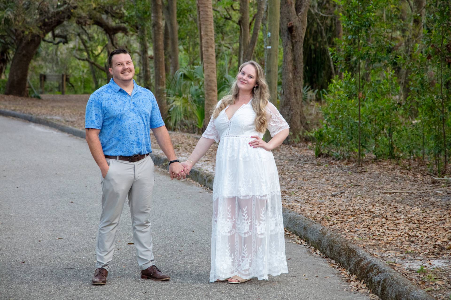 man and women standing hand in hand in the park