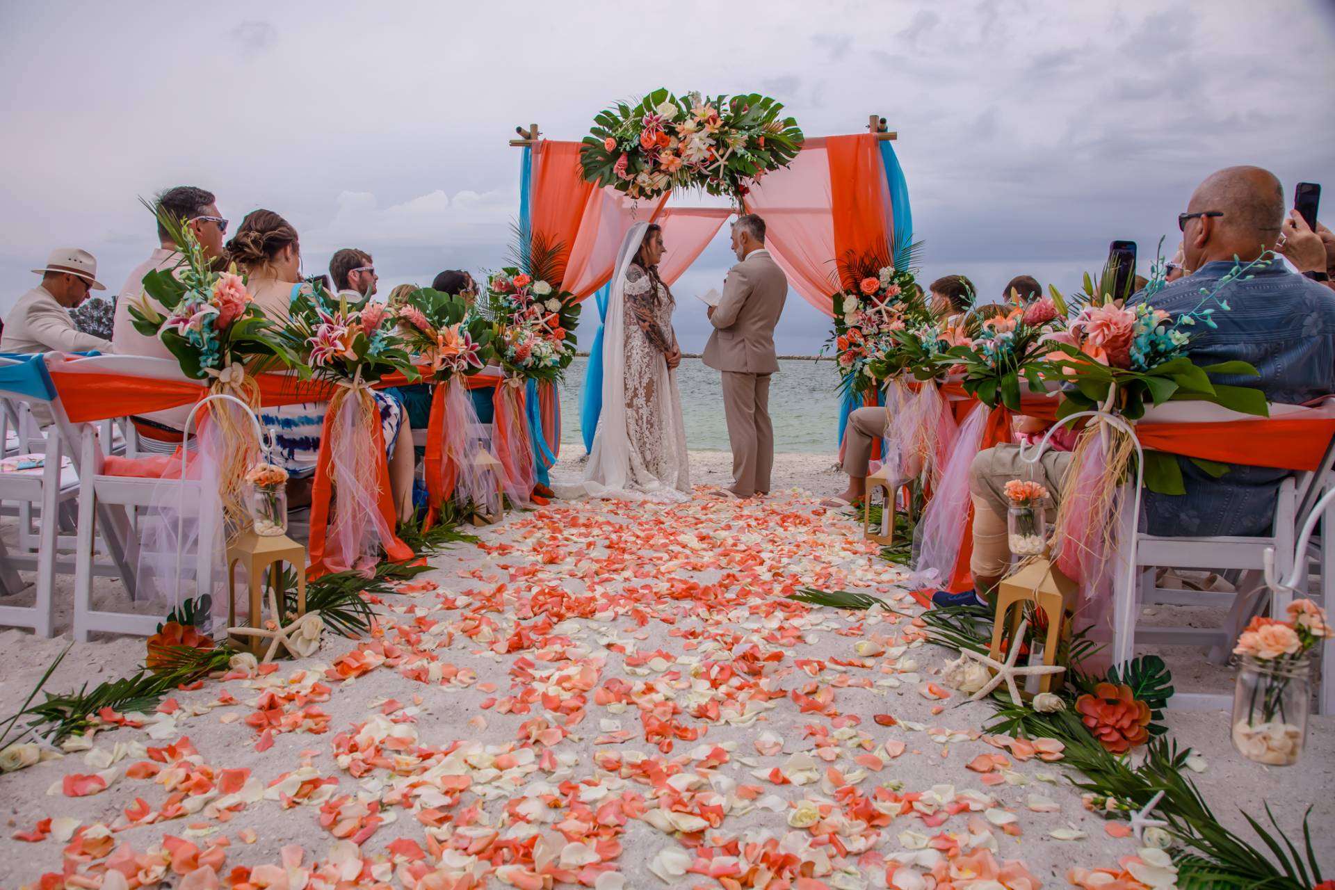 wedding ceremony on the beach with lots of flowers
